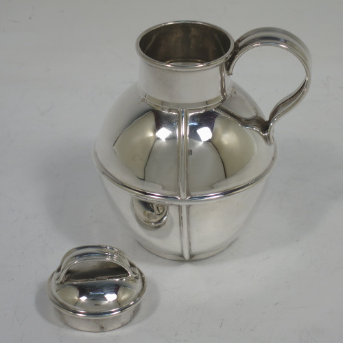 A small but handsome and unusual Antique Victorian Sterling Silver Guernsey style water / milk jug for one person, having a plain round bellied body with applied reeded girdles, a scroll handle, a pull-off lid, and all sitting on a flat base. Made by the Barnard Brothers of London in 1895. The dimensions of this fine hand-made antique silver Guernsey jug are height 9.5 cms (3.75 inches), diameter of body 7 cms (2.75 inches), and it weighs approx. 90g (3 troy ounces).