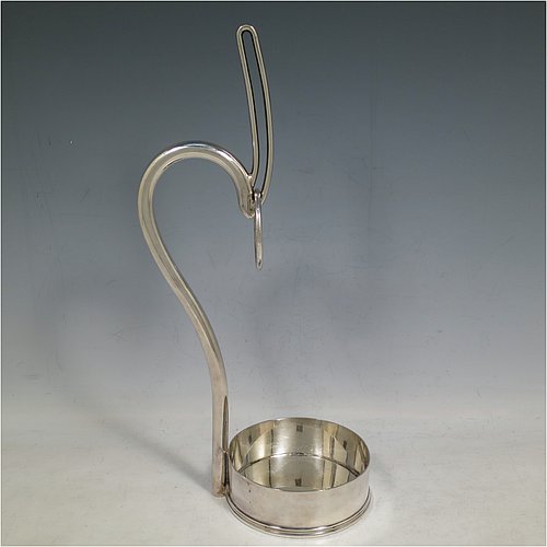 An Antique Edwardian Silver Plated wine bottle cradle or holder, having a plain round straight-sided base, and a scroll handle with sliding neck loop. Made by Harrison Brothers & Howson. The dimensions of this fine hand-made antique silver plated wine bottle holder or cradle are height 31 cms (12.5 inches), and diameter of base 10 cms (4 inches). Please note that this wine bottle cradle or holder will accept a 75cl bottle, (bottle shown for display purposes only).