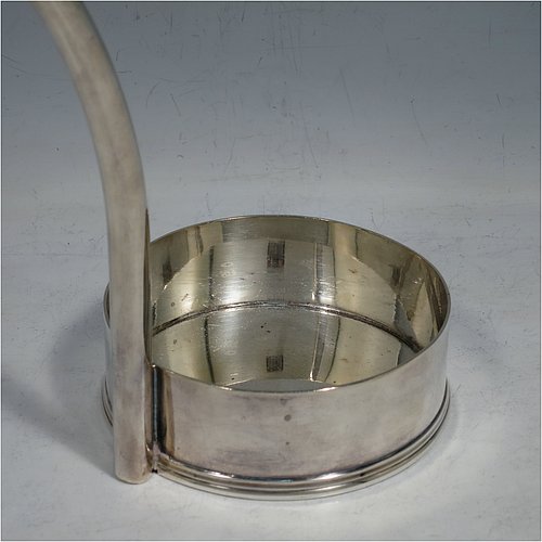 An Antique Edwardian Silver Plated wine bottle cradle or holder, having a plain round straight-sided base, and a scroll handle with sliding neck loop. Made by Harrison Brothers & Howson. The dimensions of this fine hand-made antique silver plated wine bottle holder or cradle are height 31 cms (12.5 inches), and diameter of base 10 cms (4 inches). Please note that this wine bottle cradle or holder will accept a 75cl bottle, (bottle shown for display purposes only).