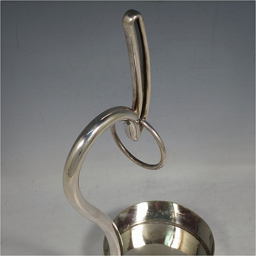 An Antique Edwardian Silver Plated wine bottle cradle or holder, having a plain round straight-sided base, and a scroll handle with sliding neck loop. Made by Harrison Brothers & Howson. The dimensions of this fine hand-made antique silver plated wine bottle holder or cradle are height 31 cms (12.5 inches), and diameter of base 10 cms (4 inches). Please note that this wine bottle cradle or holder will accept a 75cl bottle, (bottle shown for display purposes only).