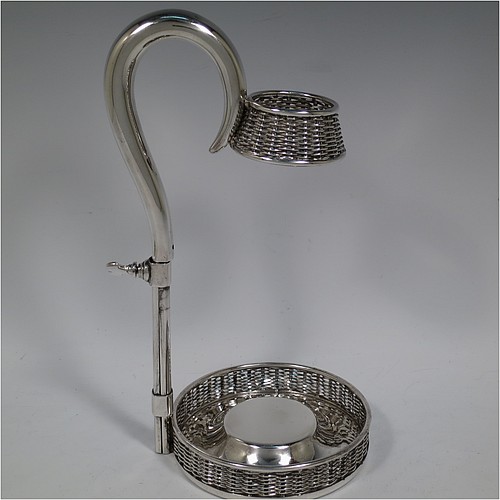 An Antique Victorian Silver Plated wine bottle cradle or holder, having a round straight-sided base with basket-weave hand-pierced decoration, a plain sliding scroll handle with matching basket weave neck and retaining screw. Made by J. and B. of Sheffield in ca. 1870. The dimensions of this fine hand-made antique silver-plated wine bottle holder or cradle are height 26 cms (10 inches), or 33 cms (13 inches) extended, and diameter of base 11.5 cms (4.5 inches). Please note that this wine bottle cradle or holder will accept a 75cl bottle, (bottle shown for display purposes only).