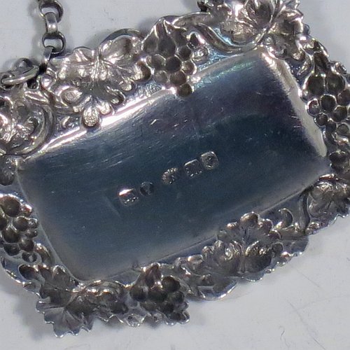An Antique Victorian Sterling Silver wine decanter label, having a shaped rectangular body, with applied grape and vine-leaf border, hand-engraved for Sherry, and with its original bottle chain. Made by Joseph Wilmore of Birmingham in 1840. The dimensions of this fine hand-made antique silver decanter wine label are height 3.5 cms (1.3 inches), length 4.5 cms (1.75 inches), and it weighs approx. 12g (0.38 troy ounces).