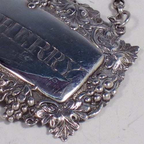 An Antique Victorian Sterling Silver wine decanter label, having a shaped rectangular body, with applied grape and vine-leaf border, hand-engraved for Sherry, and with its original bottle chain. Made by Joseph Wilmore of Birmingham in 1840. The dimensions of this fine hand-made antique silver decanter wine label are height 3.5 cms (1.3 inches), length 4.5 cms (1.75 inches), and it weighs approx. 12g (0.38 troy ounces).