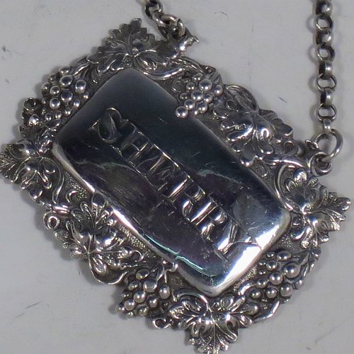 An Antique Victorian Sterling Silver wine decanter label, having a shaped rectangular body, with applied grape and vine-leaf border, hand-engraved for Sherry, and with its original bottle chain. Made by Joseph Wilmore of Birmingham in 1840. The dimensions of this fine hand-made antique silver decanter wine label are height 3.5 cms (1.3 inches), length 4.5 cms (1.75 inches), and it weighs approx. 12g (0.38 troy ounces).