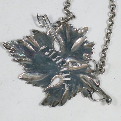 An Antique Georgian Sterling Silver wine decanter label, having a shaped vine-leaf and branch body, all hand-chased with vein and stipple work, hand-pierced for Sherry, and with its original bottle chain. Made by George Rawlings of London in 1823. The dimensions of this fine hand-made antique silver decanter wine label are height 6 cms (2.3 inches), length 8 cms (3 inches), and it weighs approx. 25g (0.8 troy ounces).