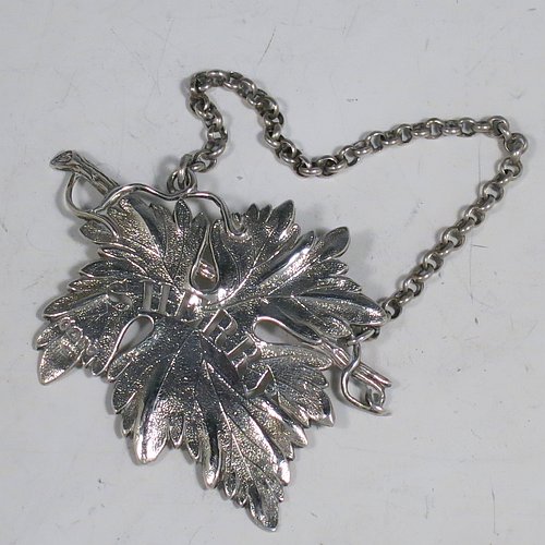 An Antique Georgian Sterling Silver wine decanter label, having a shaped vine-leaf and branch body, all hand-chased with vein and stipple work, hand-pierced for Sherry, and with its original bottle chain. Made by George Rawlings of London in 1823. The dimensions of this fine hand-made antique silver decanter wine label are height 6 cms (2.3 inches), length 8 cms (3 inches), and it weighs approx. 25g (0.8 troy ounces).