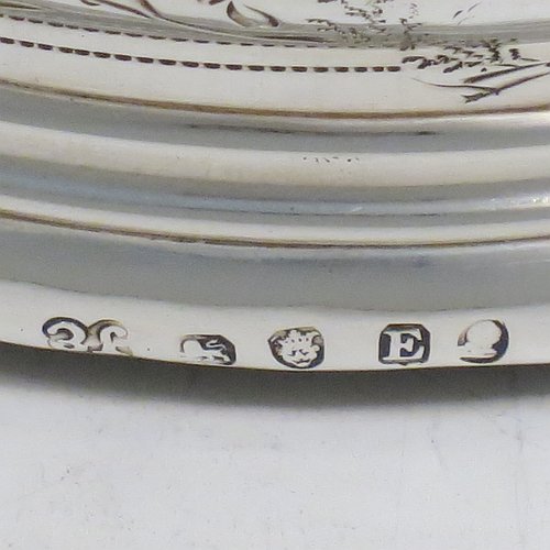 An Antique Georgian Sterling Silver very handsome and heavy set of four table wine bottle coasters, having round bellied bodies, with applied reed-edged borders and bands of hand-engraved floral decoration, and with wood-turned bases. Made by John Emes of London in 1800. The dimensions of these fine hand-made antique silver wine bottle coasters are diameter 13 cms (5 inches), and height 4 cms (1.5 inches). Please note that one of the coaster woods has been replaced at a later date and is of a slightly different colour.   