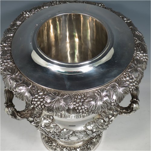 An Antique Georgian Old Sheffield plated wine cooler, in the Campagna style, with cast grape & vine borders, a pair of cast handles, and an applied oak acorn & leaf band running round the body. All with original interior and cover. Made in ca. 1825. The dimensions of this fine hand-made antique Old Sheffield wine cooler are height 29 cms (11.5 inches), width across handles 25 cms (9.75 inches). Please note that this item has an original crested inlet cartouche.