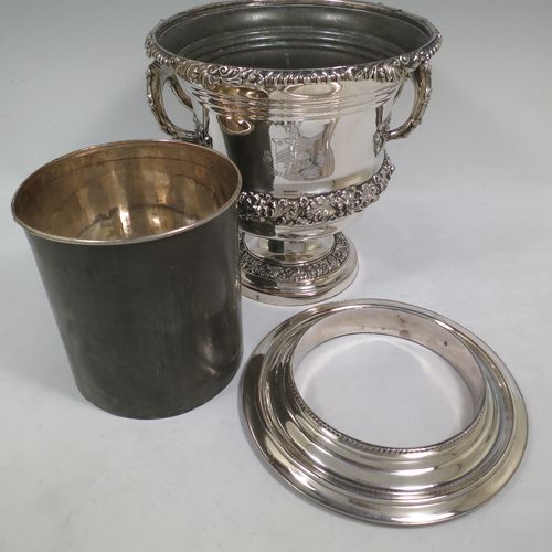 A very handsome Antique Georgian Old Sheffield plated wine cooler, in the Campagna style, with cast gadroon, scroll, and floral borders, a pair of cast side-handles, with original interior and cover, and all sitting on a pedestal foot. Made in ca. 1825. The dimensions of this fine hand-made antique Old Sheffield wine cooler are height 24.5 cms (9.75 inches), width across handles 21 cms (8.25 inches). Please note that this item is crested.