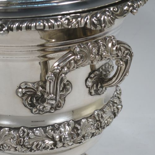 A very handsome Antique Georgian Old Sheffield plated wine cooler, in the Campagna style, with cast gadroon, scroll, and floral borders, a pair of cast side-handles, with original interior and cover, and all sitting on a pedestal foot. Made in ca. 1825. The dimensions of this fine hand-made antique Old Sheffield wine cooler are height 24.5 cms (9.75 inches), width across handles 21 cms (8.25 inches). Please note that this item is crested.