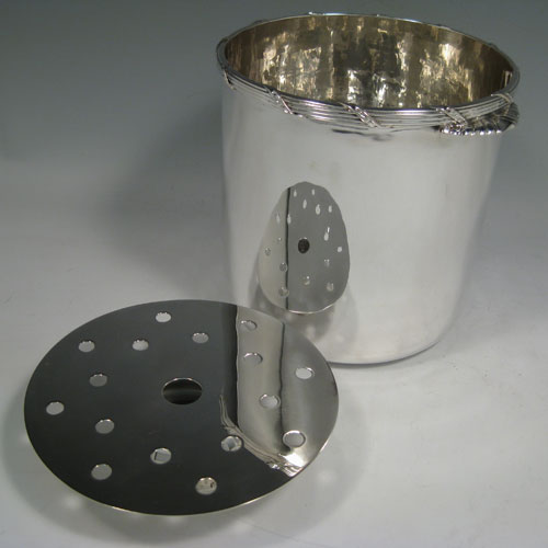 Antique Edwardian sterling silver wine cooler, having a plain cylindrical body, a ribbon and reed top border, two cast fluted handles, and a removable pierced drainer. Made by C.J. Vanders of London in 1906 (originally retailed by Tessiers). Height 16.5 cms (6.5 inches), diameter at top 16.5 cms (6.5 inches). Total weight approx. 1,200g (38.7 troy ounces).