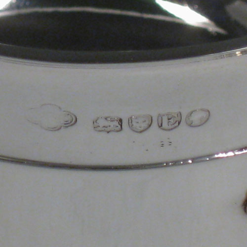 Antique Victorian sterling silver Arts and Crafts wine cooler, having a plain round body with three three handles and medieval style decoration. Made by J.B. Carrington of London in 1880. Height 18.5 cms (7.25 inches), diameter 15 cms (6 inches). Weight approx. 1,375g (44 troy ounces).