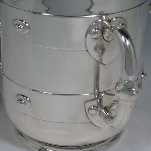 Antique Victorian sterling silver Arts and Crafts wine cooler, having a plain round body with three three handles and medieval style decoration. Made by J.B. Carrington of London in 1880. Height 18.5 cms (7.25 inches), diameter 15 cms (6 inches). Weight approx. 1,375g (44 troy ounces).