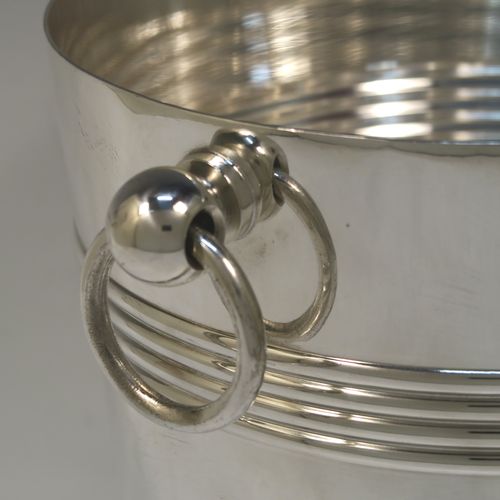 A very handsome Antique French Silver Plated wine bottle cooler, having a plain round body with tapering sides, with two bands of hand-engraved reeded decoration, and two cast ring side-handles, all sitting on a flat base. Made in ca. 1930 by the French silversmith Christophle. The dimensions of this fine hand-made antique silver-plated wine cooler are height 20 cms (8 inches), and diameter at lip 19 cms (7.5 inches). Please note that this will easily hold a magnum size bottle.  