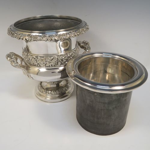 A very handsome Antique Georgian Old Sheffield plated wine cooler, in the Campagna style, with cast gadroon, scroll, and floral borders, a pair of cast side-handles, with a central applied band of grape-vine work, with its original tin-backed interior liner and cover, and all sitting on a pedestal foot. This beautiful antique Old Sheffield plated wine cooler was made in ca. 1825. The dimensions of this fine hand-made antique Old Sheffield wine cooler are height 23 cms (9 inches), and width across handles 26 cms (10.25 inches).