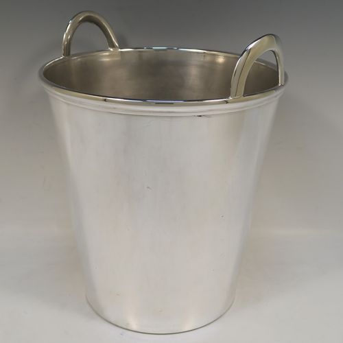 A large and very elegant Art Deco style Silver Plated wine bottle cooler, having a plain round body with tapering sides, and two cast loop side-handles, all sitting on a flat base. This beautiful silver-plated wine cooler was made in ca. 1930. The dimensions of this fine hand-made silver-plated Art Deco wine cooler are height 27 cms (10.5 inches), and diameter at lip 22 cms (8.75 inches). Please note that this will easily hold two normal size wine bottles.