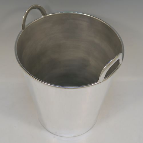 A large and very elegant Art Deco style Silver Plated wine bottle cooler, having a plain round body with tapering sides, and two cast loop side-handles, all sitting on a flat base. This beautiful silver-plated wine cooler was made in ca. 1930. The dimensions of this fine hand-made silver-plated Art Deco wine cooler are height 27 cms (10.5 inches), and diameter at lip 22 cms (8.75 inches). Please note that this will easily hold two normal size wine bottles.