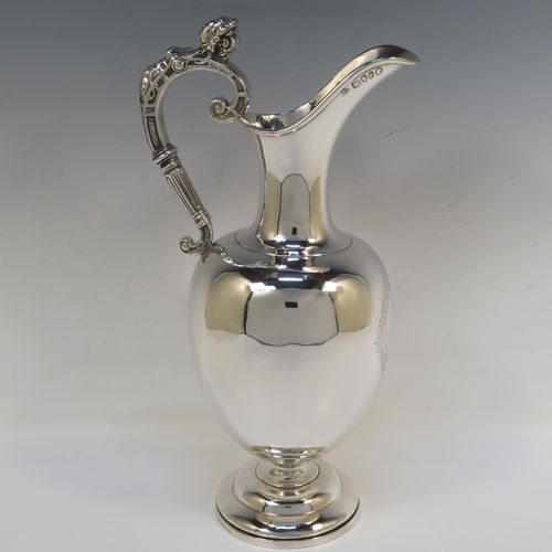 A very handsome Antique Victorian Sterling Silver wine ewer, having a plain round bellied body, a cast figural scroll handle, an elegant plain spout with an applied rim, and all sitting on a round pedestal foot. This beautiful antique silver ewer was made by James Samuel Hunt (the Royal Silversmith of the time) of London in 1864. The dimensions of this fine hand-made antique silver wine ewer are height 30 cms (11.75 inches), length 15 cms (6 inches), and it weighs approx. 676g (21.8 troy ounces). Please note that this item has a vacant cartouche at the front surrounded by a hand-engraved Latin inscription, Fortiter In Re (Gentle in Manner, Firm in Action).
