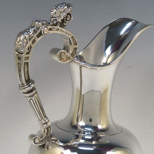 A very handsome Antique Victorian Sterling Silver wine ewer, having a plain round bellied body, a cast figural scroll handle, an elegant plain spout with an applied rim, and all sitting on a round pedestal foot. This beautiful antique silver ewer was made by James Samuel Hunt (the Royal Silversmith of the time) of London in 1864. The dimensions of this fine hand-made antique silver wine ewer are height 30 cms (11.75 inches), length 15 cms (6 inches), and it weighs approx. 676g (21.8 troy ounces). Please note that this item has a vacant cartouche at the front surrounded by a hand-engraved Latin inscription, Fortiter In Re (Gentle in Manner, Firm in Action).