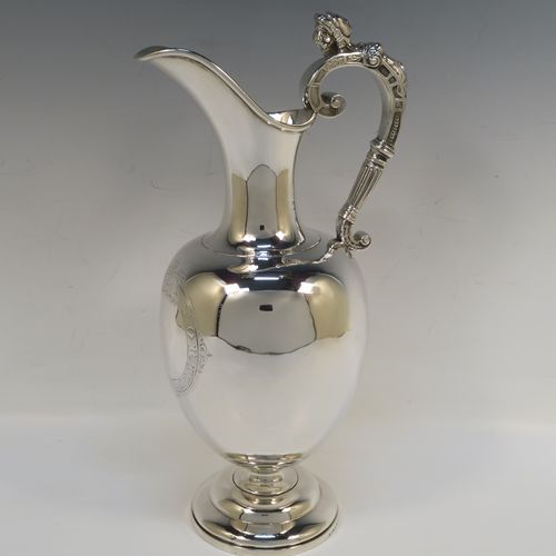 A very handsome Antique Victorian Sterling Silver wine ewer, having a plain round bellied body, a cast figural scroll handle, an elegant plain spout with an applied rim, and all sitting on a round pedestal foot. This beautiful antique silver ewer was made by James Samuel Hunt (the Royal Silversmith of the time) of London in 1864. The dimensions of this fine hand-made antique silver wine ewer are height 30 cms (11.75 inches), length 15 cms (6 inches), and it weighs approx. 676g (21.8 troy ounces). Please note that this item has a vacant cartouche at the front surrounded by a hand-engraved Latin inscription, Fortiter In Re (Gentle in Manner, Firm in Action).