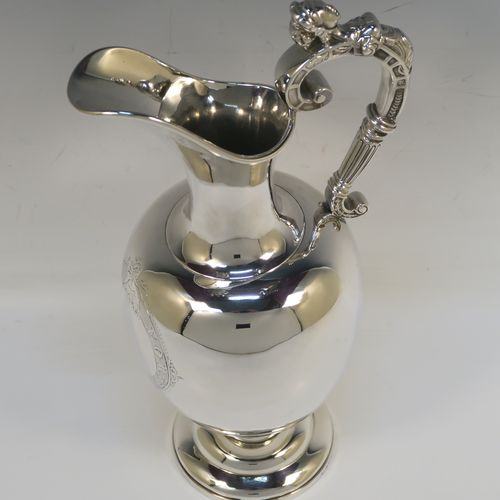 A very handsome Antique Victorian Sterling Silver wine ewer, having a plain round bellied body, a cast figural scroll handle, an elegant plain spout with an applied rim, and all sitting on a round pedestal foot. This beautiful antique silver ewer was made by James Samuel Hunt (the Royal Silversmith of the time) of London in 1864. The dimensions of this fine hand-made antique silver wine ewer are height 30 cms (11.75 inches), length 15 cms (6 inches), and it weighs approx. 676g (21.8 troy ounces). Please note that this item has a vacant cartouche at the front surrounded by a hand-engraved Latin inscription, Fortiter In Re (Gentle in Manner, Firm in Action).