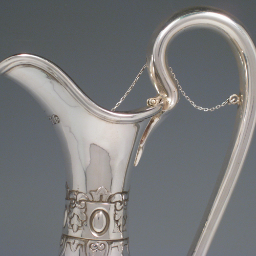 Antique Victorian sterling silver hand-chased wine ewer with unusual opening chain mechanism, with floral swags and cast ladies faces. Made by the Barnard Brothers of London in 1871. Height 35 cms (13.75