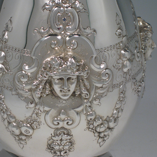 Antique Victorian sterling silver hand-chased wine ewer with unusual opening chain mechanism, with floral swags and cast ladies faces. Made by the Barnard Brothers of London in 1871. Height 35 cms (13.75