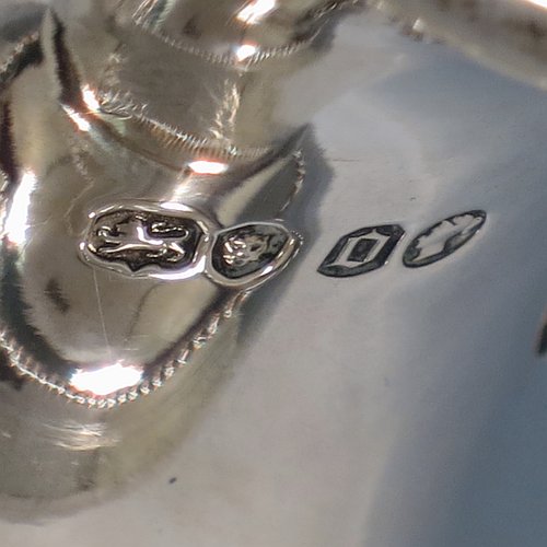 An Antique Victorian Sterling Silver wine ewer, having an amphora style round bellied body, with a band of hand-engraved floral decoration, together with applied bead borders, a lid with flat invisible hinge, a scroll handle with thumb-piece, and all sitting on a pedestal foot. Made by Arthur Sibley of London in 1869. The dimensions of this fine hand-made antique silver wine ewer are height 34 cms (13.3 inches), length 16 cms (6.25 inches), and it weighs approx. 848g (27 troy ounces).