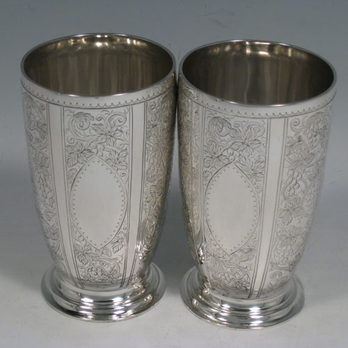 Antique Victorian sterling silver wine ewer and two beakers, having hand-engraved grape-vine and leaf decoration. Made by Martin Hall and Co., of London in 1878. Height of ewer 28 cms (11 inches), height of beakers 11.5 cms (4.5 inches). Total weight approx. 805g (26 troy ounces).