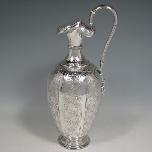 Antique Victorian sterling silver wine ewer and two beakers, having hand-engraved grape-vine and leaf decoration. Made by Martin Hall and Co., of London in 1878. Height of ewer 28 cms (11 inches), height of beakers 11.5 cms (4.5 inches). Total weight approx. 805g (26 troy ounces).