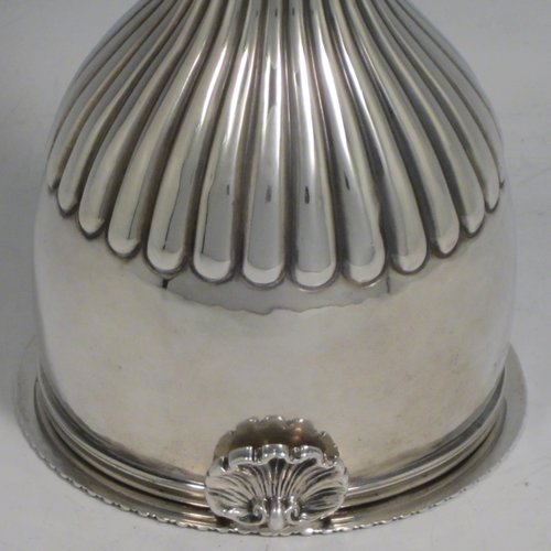 Antique Georgian sterling silver wine decanting funnel, having a round body with hand-chased half-fluted decoration, and a pull out strainer with a shell clip and gadroon border. Made by Alexander Field of London in 1816. The dimensions of this fine hand-made silver wine decanting funnel are height 15 cms (6 inches), diameter of cup 8.5 cms (3.25 inches), and it weighs approx. 117g (3.7 troy ounces).