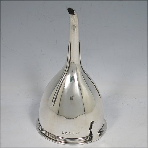 An Antique Georgian Sterling Silver wine decanting funnel, having a round body with applied reeded border and funnel struts (that allow proper aeration when decanting), a pull out strainer with a shaped clip, and an original muslin ring. Made by Alexander Field of London in 1801. Crested. The dimensions of this fine hand-made antique silver wine decanting funnel are height 14.5 cms (5.75 inches), diameter of cup 8 cms (3.25 inches), and it weighs approx. 155g (5 troy ounces).   