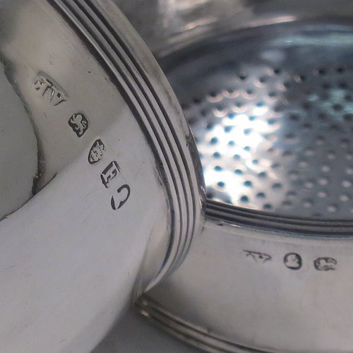 An Antique Georgian Sterling Silver wine decanting funnel, having a round body with applied reeded border and funnel struts (that allow proper aeration when decanting), a pull out strainer with a shaped clip, and an original muslin ring. Made by Alexander Field of London in 1801. Crested. The dimensions of this fine hand-made antique silver wine decanting funnel are height 14.5 cms (5.75 inches), diameter of cup 8 cms (3.25 inches), and it weighs approx. 155g (5 troy ounces).
