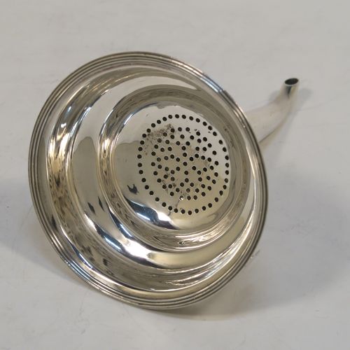 A very handsome Antique Georgian Sterling Silver wine decanting funnel, having a plain round body with applied reeded borders, an original muslin ring and a side clip, and original removable funnel. This elegant antique silver wine funnel was made by Elizabeth Morley of London in 1810. The dimensions of this fine hand-made antique silver wine decanting funnel are height 13 cms (5.25 inches), diameter of bowl 9 cms (3.5 inches), and it weighs approx. 102g (3.3 troy ounces).