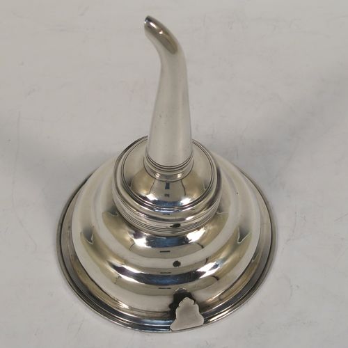 A very handsome Antique Georgian Sterling Silver wine decanting funnel, having a plain round body with applied reeded borders, an original muslin ring and a side clip, and original removable funnel. This elegant antique silver wine funnel was made by Elizabeth Morley of London in 1810. The dimensions of this fine hand-made antique silver wine decanting funnel are height 13 cms (5.25 inches), diameter of bowl 9 cms (3.5 inches), and it weighs approx. 102g (3.3 troy ounces).