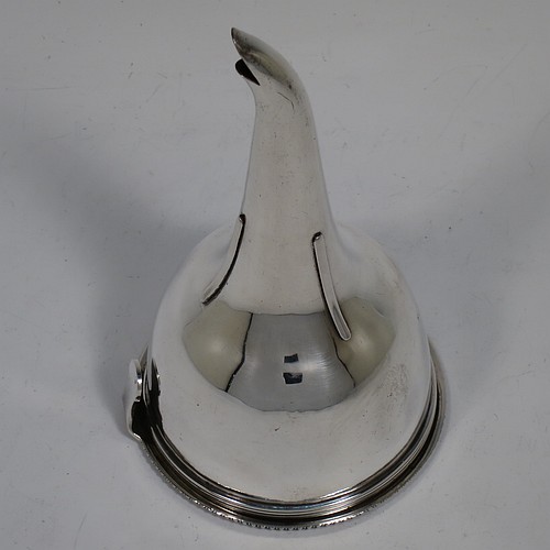 An Antique Georgian Sterling Silver wine decanting funnel, having a round body with applied reeded border and funnel struts (that allow proper aeration when decanting), a pull out hand-pierced strainer with an applied gadroon border and shaped clip, and an original muslin ring. Made by Rebecca Emes and Edward Barnard of London in 1808. The dimensions of this fine hand-made antique silver wine decanting funnel are height 15 cms (6 inches), diameter of cup 8.5 cms (3.3 inches), and it weighs approx. 162g (5.2 troy ounces).