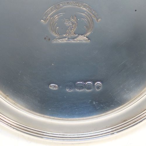 A very elegant and rare pair of Antique Georgian Sterling Silver wine decanting funnel stands or plates, having plain round bodies with applied reeded borders. This beautiful pair of wine funnel stands were made by George Reid of London in 1828. The dimensions of this fine hand-made antique silver pair of wine decanting funnel plates are outer diameter 9.5 cms (3.75 inches), inner diameter within the reeded border 8.5 cms (3.3 inches), and they weigh a total of approx. 114g (3.7 troy ounces). Please note that these items are crested.