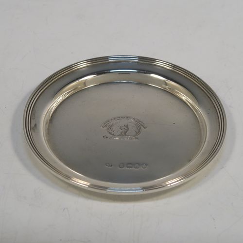 A very elegant and rare pair of Antique Georgian Sterling Silver wine decanting funnel stands or plates, having plain round bodies with applied reeded borders. This beautiful pair of wine funnel stands were made by George Reid of London in 1828. The dimensions of this fine hand-made antique silver pair of wine decanting funnel plates are outer diameter 9.5 cms (3.75 inches), inner diameter within the reeded border 8.5 cms (3.3 inches), and they weigh a total of approx. 114g (3.7 troy ounces). Please note that these items are crested.