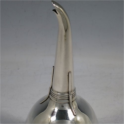 An Antique Georgian Sterling Silver wine decanting funnel, having a round body with an applied gadroon border and funnel struts (that allow proper aeration when decanting), a pull out strainer with a shaped clip, and an original muslin ring. Made by William Bateman of London in 1811. The dimensions of this fine hand-made antique silver wine decanting funnel are height 16 cms (6.3 inches), diameter of cup 8.5 cms (3.3 inches), and it weighs approx. 147g (4.7 troy ounces).