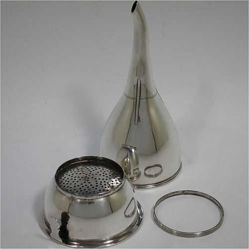 An Antique Georgian Sterling Silver wine decanting funnel, having a round plain body with applied reeded border and funnel struts (that allow proper aeration when decanting), a pull out hand-pierced strainer with an applied reeded border and shaped clip, and an original muslin ring. Made by William Bateman of London in 1820. The dimensions of this fine hand-made antique silver wine decanting funnel are height 16 cms (6.3 inches), diameter of cup 8.5 cms (3.3 inches), and it weighs approx. 158g (5 troy ounces).