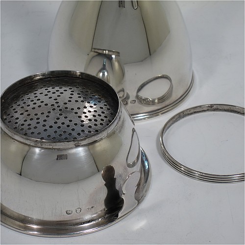 An Antique Georgian Sterling Silver wine decanting funnel, having a round plain body with applied reeded border and funnel struts (that allow proper aeration when decanting), a pull out hand-pierced strainer with an applied reeded border and shaped clip, and an original muslin ring. Made by William Bateman of London in 1820. The dimensions of this fine hand-made antique silver wine decanting funnel are height 16 cms (6.3 inches), diameter of cup 8.5 cms (3.3 inches), and it weighs approx. 158g (5 troy ounces).