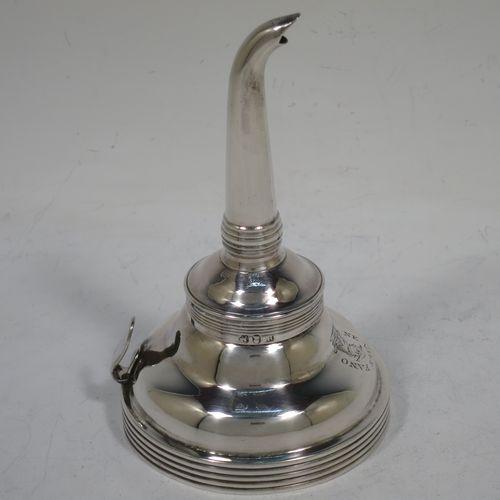 A handsome Antique Georgian Sterling Silver wine decanting funnel, having a plain round body with applied reeded borders, and removable funnel. Made by Soloman Hougham of London in 1810. The dimensions of this fine hand-made antique silver wine decanting funnel are height 13 cms (5 inches), diameter of bowl 8 cms (3 inches), and it weighs approx. 96g (3 troy ounces).   