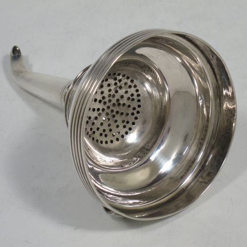 A handsome Antique Georgian Sterling Silver wine decanting funnel, having a plain round body with applied reeded borders, and removable funnel. Made by Soloman Hougham of London in 1810. The dimensions of this fine hand-made antique silver wine decanting funnel are height 13 cms (5 inches), diameter of bowl 8 cms (3 inches), and it weighs approx. 96g (3 troy ounces).