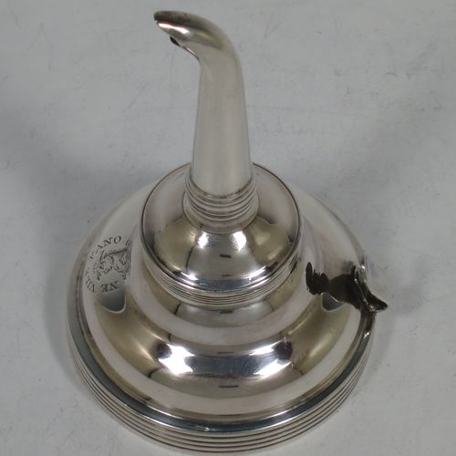 A handsome Antique Georgian Sterling Silver wine decanting funnel, having a plain round body with applied reeded borders, and removable funnel. Made by Soloman Hougham of London in 1810. The dimensions of this fine hand-made antique silver wine decanting funnel are height 13 cms (5 inches), diameter of bowl 8 cms (3 inches), and it weighs approx. 96g (3 troy ounces).