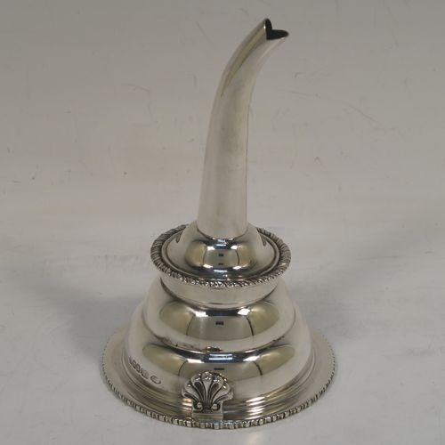 An elegant Scottish Sterling Silver wine decanting funnel, having a plain round body with a gold-gilt interior and applied gadroon borders, a cast shell side clip, and removable funnel. This handsome silver wine decanting funnel was made by Goodwins of Edinburgh in 2001. The dimensions of this fine hand-made silver wine decanting funnel are height 13 cms (5 inches), diameter of bowl 8 cms (3 inches), and it weighs approx. 127g (4 troy ounces).   