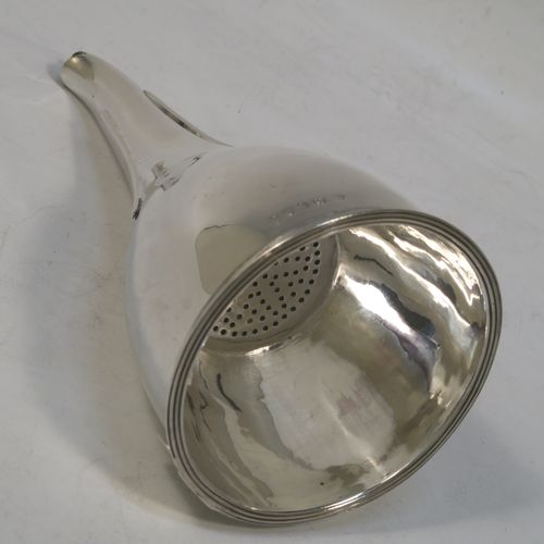 A very elegant Antique Georgian Sterling Silver wine decanting funnel, having a round plain body with an applied reeded border and funnel struts (that allow proper aeration when decanting), a pull out hand-pierced strainer with an applied reeded border and shaped clip. Made by Soloman Hougham of London in 1802. The dimensions of this fine hand-made antique silver wine decanting funnel are height 15 cms (6 inches), diameter of cup 8 cms (3.25 inches), and it weighs approx. 150g (4.8 troy ounces).