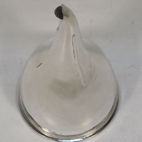 A very elegant Antique Georgian Sterling Silver wine decanting funnel, having a round plain body with an applied reeded border and funnel struts (that allow proper aeration when decanting), a pull out hand-pierced strainer with an applied reeded border and shaped clip. Made by Soloman Hougham of London in 1802. The dimensions of this fine hand-made antique silver wine decanting funnel are height 15 cms (6 inches), diameter of cup 8 cms (3.25 inches), and it weighs approx. 150g (4.8 troy ounces).