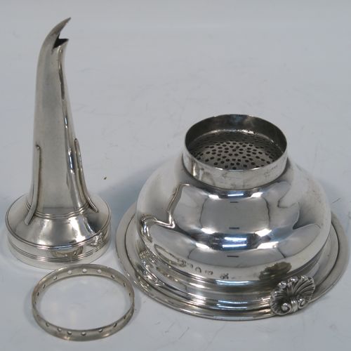 A very elegant Antique Georgian Sterling Silver wine decanting funnel, having a plain round body with applied reeded borders and a cast shell style side clip, an original muslin ring, and original removable funnel with side aeration struts. This handsome silver wine funnel was made by Emes and Barnard of London in 1819. The dimensions of this fine hand-made antique silver wine decanting funnel are height 13.5 cms (5.3 inches), diameter of bowl 9 cms (3.5 inches), and it weighs approx. 98g (3.2 troy ounces).