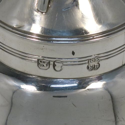 A very elegant Antique Georgian Sterling Silver wine decanting funnel, having a plain round body with applied reeded borders and a cast shell style side clip, an original muslin ring, and original removable funnel with side aeration struts. This handsome silver wine funnel was made by Emes and Barnard of London in 1819. The dimensions of this fine hand-made antique silver wine decanting funnel are height 13.5 cms (5.3 inches), diameter of bowl 9 cms (3.5 inches), and it weighs approx. 98g (3.2 troy ounces).
