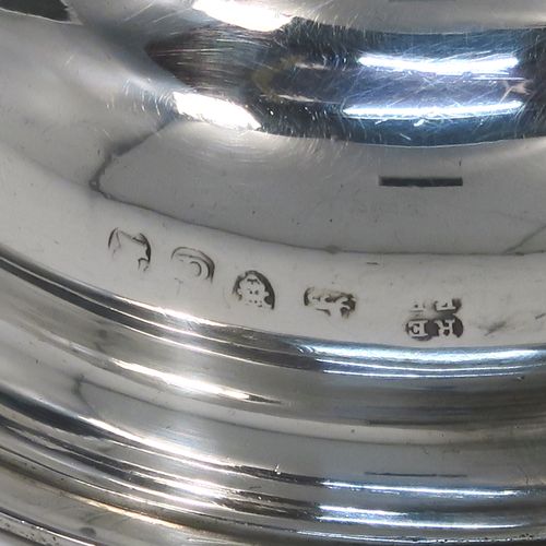 A very elegant Antique Georgian Sterling Silver wine decanting funnel, having a plain round body with applied reeded borders and a cast shell style side clip, an original muslin ring, and original removable funnel with side aeration struts. This handsome silver wine funnel was made by Emes and Barnard of London in 1819. The dimensions of this fine hand-made antique silver wine decanting funnel are height 13.5 cms (5.3 inches), diameter of bowl 9 cms (3.5 inches), and it weighs approx. 98g (3.2 troy ounces).